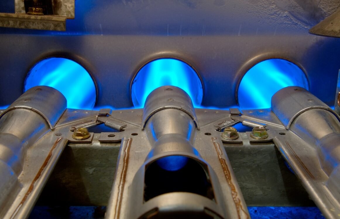 most efficient heating system Inside a gas furnace. Focus = the top of the middle flange.