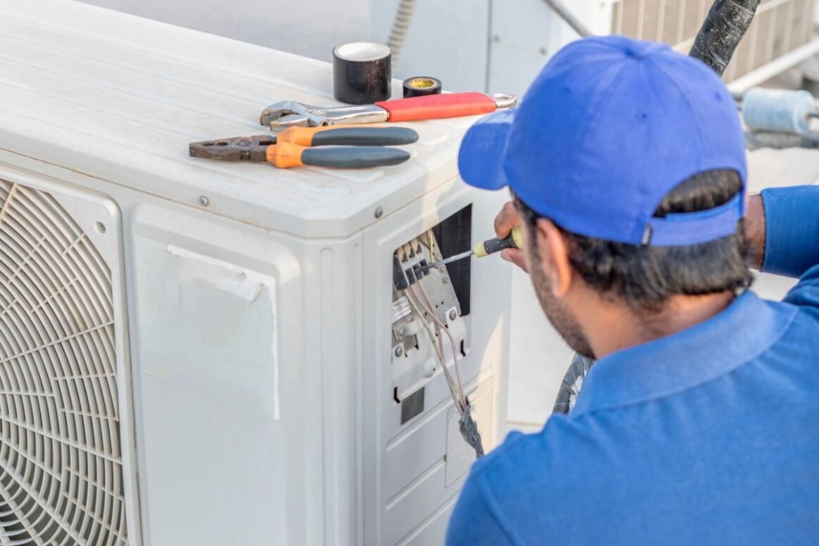electrician fixing central air conditioning system