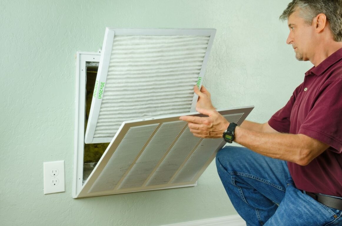 professional repair service man changing air filter
