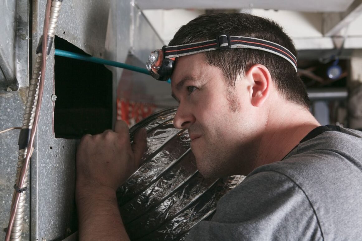 furnace duct cleaning worker clean pipes